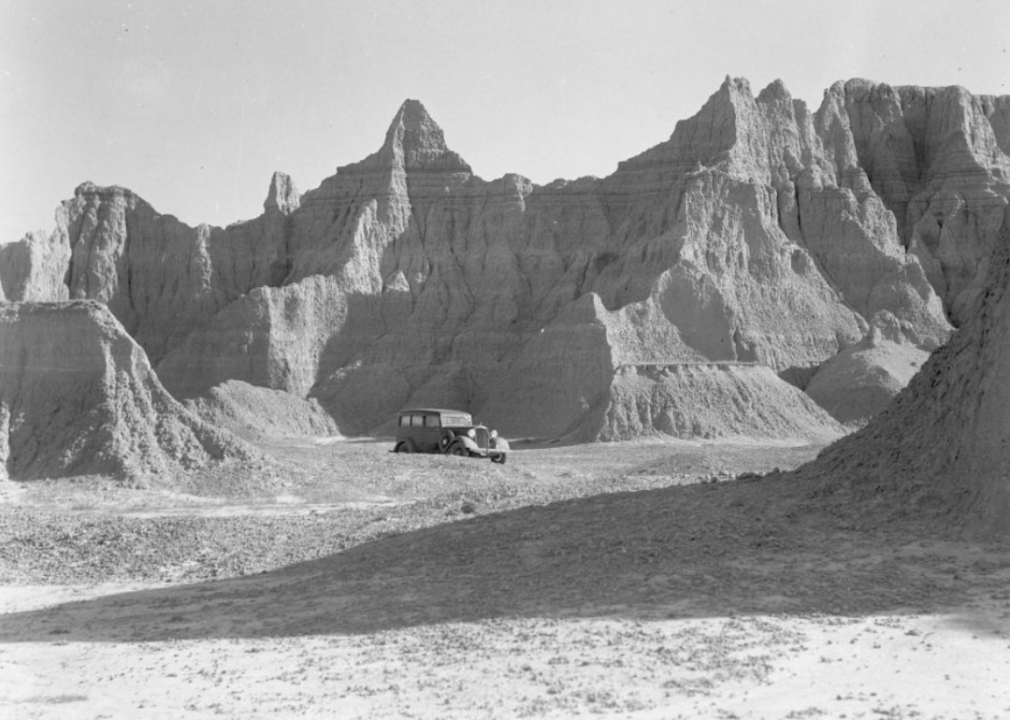 Vehicle and Badlands geological formations